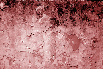 Grungy dirty plaster wall with peeling paint. Red color style.