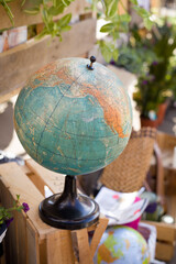 Close-up of a vintage globe outdoors. Old globe on the street market. School globe.