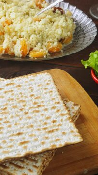 Matzo and menorah on the holiday table with traditional Passover Seder snacks. Vertical video