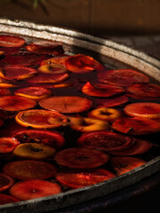 large outdoor vat with mulled wine and fruit