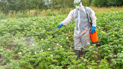 Man treats plants from pests and weeds, farmer applying chemical fertilizer spraying aerosol mixture, agriculture concept