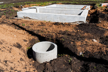 Installing concrete foundation and drainage system at construction site involves excavation,...
