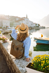 Young woman enjoying beautiful cityscape on high viewpoint. Lifestyle, travel, rest, weekend,...