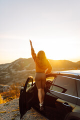 Young woman tourist on road, enjoying window view and traveling  on holiday road trip. Travel...