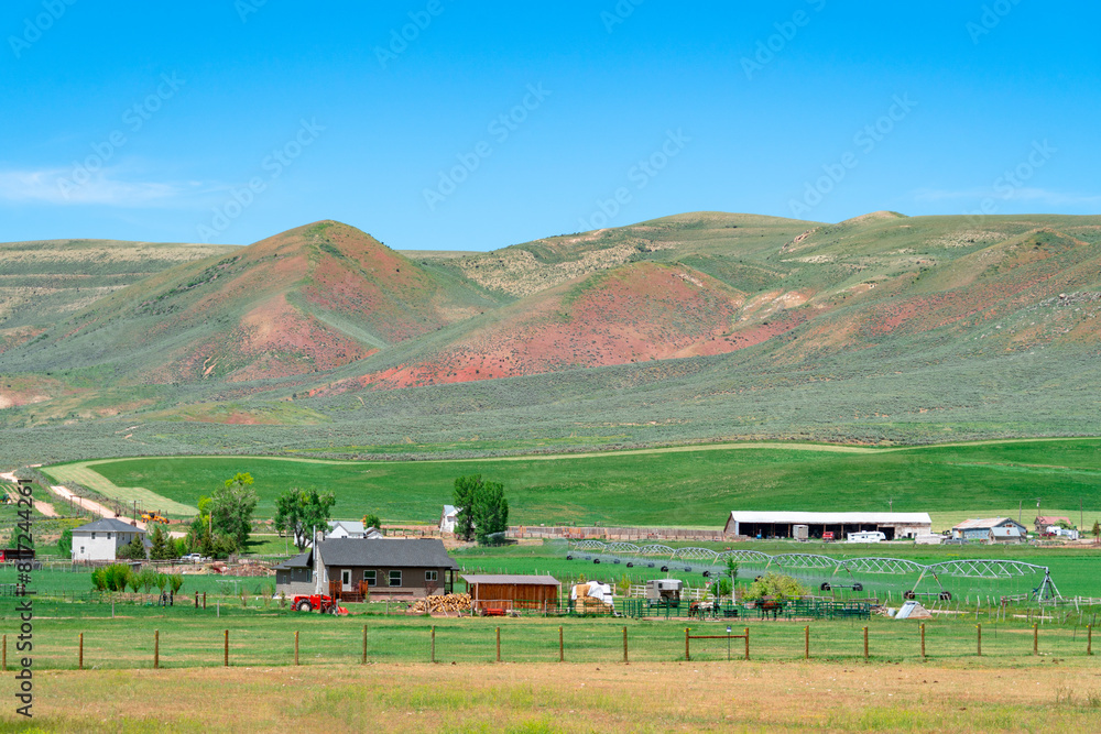 Wall mural landscape of farm in mountain valley