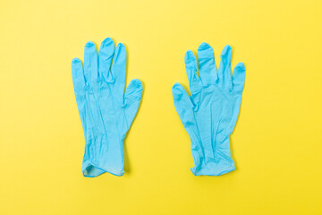 Two blue latex medical gloves on bright background. Minimal Coronavirus outbreak. Panic concept.