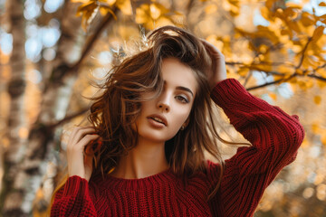 Naklejka premium A woman with long brown hair is wearing a red sweater