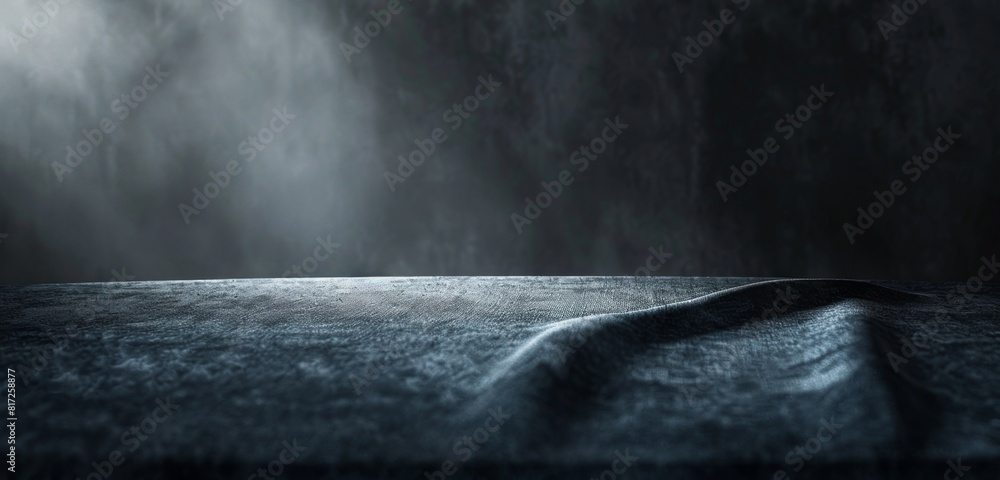 Poster black background with a gray table in the foreground, illuminated by soft light from above texture o