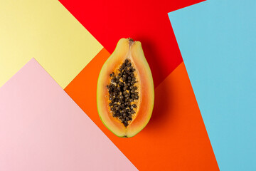 Creative tropical layout with papaya on colorful vivid paper. Minimal abstract summer concept. Flat lay.