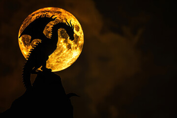A dragon is standing on a rock in front of a full moon