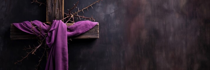 A symbolic representation of the crucifixion with a crown of thorns and purple cloth on a wooden cross and dark background