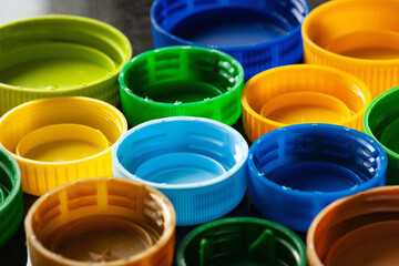 Plastic caps. Multicolored plastic lids. Recycling of plastic. Selective focus