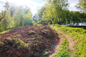 Dug up earth in a picturesque area after laying a gas pipeline, gasification in the countryside