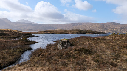 Stunning water view over Lewisian gneiss precambrian metamorphic rock landscape on Loch Inver,...
