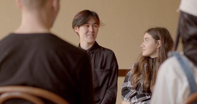 Young people engaging in group discussion. Individuals exchanging ideas, sharing opinions, discussing topics or issues collectively within group setting. Discussions promote critical thinking in youth - Powered by Adobe