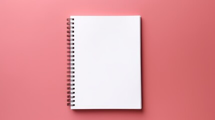 An empty notebook photographed from a top down perspective on a bicolor background