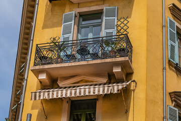 Architectural fragments of the facades of ancient houses in Nice: beautiful windows, balconies,...