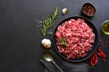 Homemade minced meat with ingredients for making in a bowl . Top view.