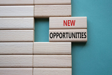 New Opportunities symbol. Concept word New Opportunities on wooden blocks. Beautiful grey green background. Business and New Opportunities concept. Copy space