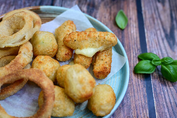 Selection of fast food snack. italian cheese breaded Mozzarella Sticks, Jalapeno Cheese nuggets, Onion Rings and mayo sauce.Italian street junk food