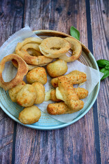 Selection of fast food snack. italian cheese breaded Mozzarella Sticks, Jalapeno Cheese nuggets, Onion Rings and mayo sauce.Italian street junk food