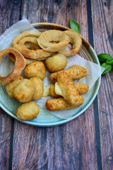 Selection of fast food snack. italian cheese breaded Mozzarella Sticks, Jalapeno Cheese nuggets, Onion Rings and mayo sauce.Italian street junk food
