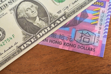Comparison of dollar bill with hong kong dollar, concept of inflation or abundance