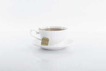 Tasty tea in cup on white background