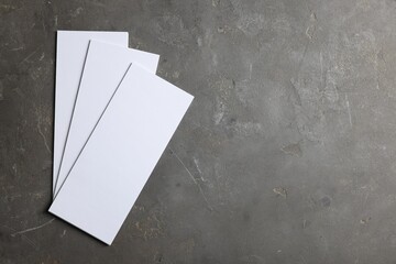 Blank business cards on grey textured background, top view. Mockup for design