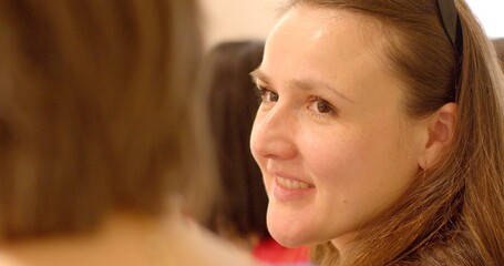 Close-up portrait of a woman speaking indoors. Expressive communication and dialogue in a professional or personal setting. Indoor conversation or presentation captured in detail, human female face.