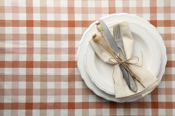 Stylish setting with cutlery and plates on table, top view. Space for text
