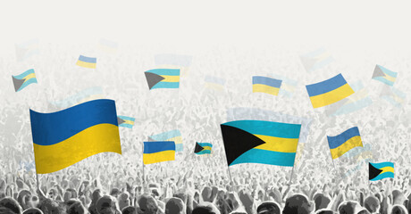 People waving flag of The Bahamas and Ukraine, symbolizing The Bahamas solidarity for Ukraine.