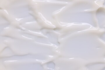 Texture of face care cream as background, top view