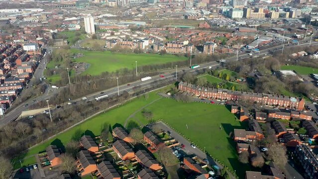 Aerial footage of the town known as Holbeck in Leeds West Yorkshire UK, showing rows of houses in a typical British housing estate taken in the wintertime near the M621 motorway.