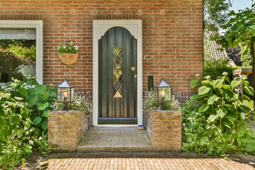 Traditional home entrance with brick wall and plants