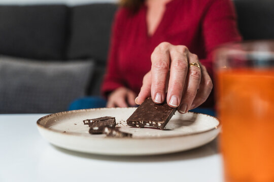 Woman Choosing a Piece of Chocolate for Hypoglycemia
