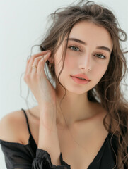 Fototapeta premium photo of a beautiful woman in a delicate black bodysuit with a light background