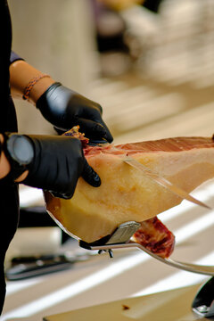 Expertly slicing premium ham at a gourmet buffet