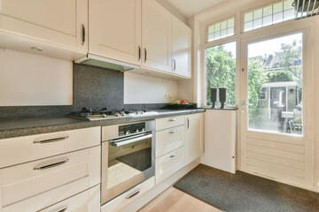 Modern kitchen interior with garden view at Meester Rendorplaan 8