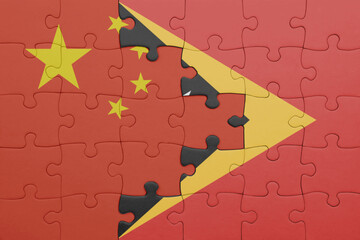 puzzle with the colourful national flag of east timor and flag of china .