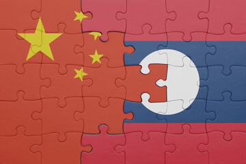 puzzle with the colourful national flag of laos and flag of china .