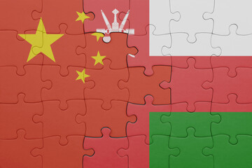 puzzle with the colourful national flag of oman and flag of china .