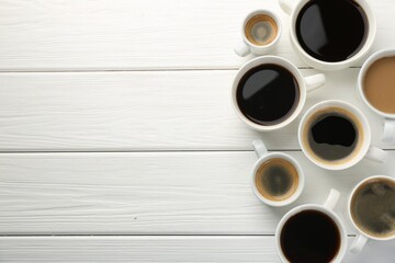 Different coffee drinks in cups on white wooden table, flat lay. Space for text