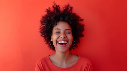 A woman with curly hair is laughing heartily, dressed in a red t-shirt that matches the vibrant backdrop - Generative AI