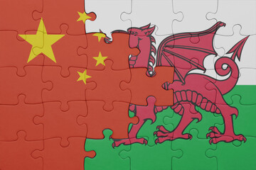 puzzle with the colourful national flag of wales and flag of china .
