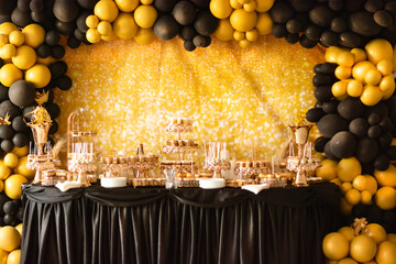 Details, holiday accessories Photo zones of a table with candy bar sweets, decorated with gold and...