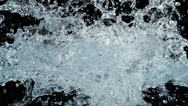 Super Slow Motion Shot of Pure Water Splashes Flying Towards Isolated on Black at 1000fps.