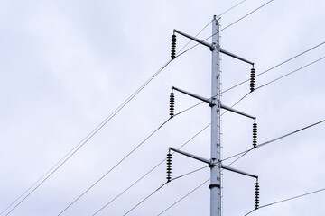 Electrical tower with high voltage cables, day with cloudy weather and a rainy tendency