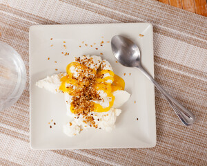 Homemade hearty breakfast - cottage cheese with honey sauce. dish is richly decorated with sesame...