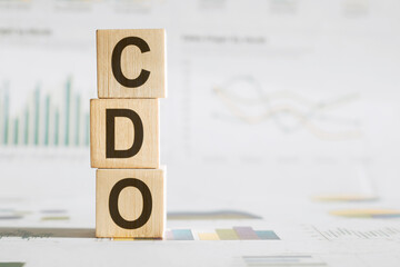 CDO - text on wooden cubes, on office table background. collateralized debt obligations or chief...